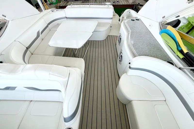 Obstreperous Yacht Photos Pics Luxurious interior of a 2004 Formula 400 Super Sport boat with white seating and table.