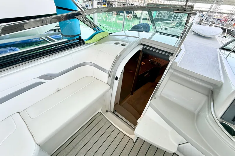 Obstreperous Yacht Photos Pics 2004 Formula 400 Super Sport yacht interior with white seating and open cabin door.