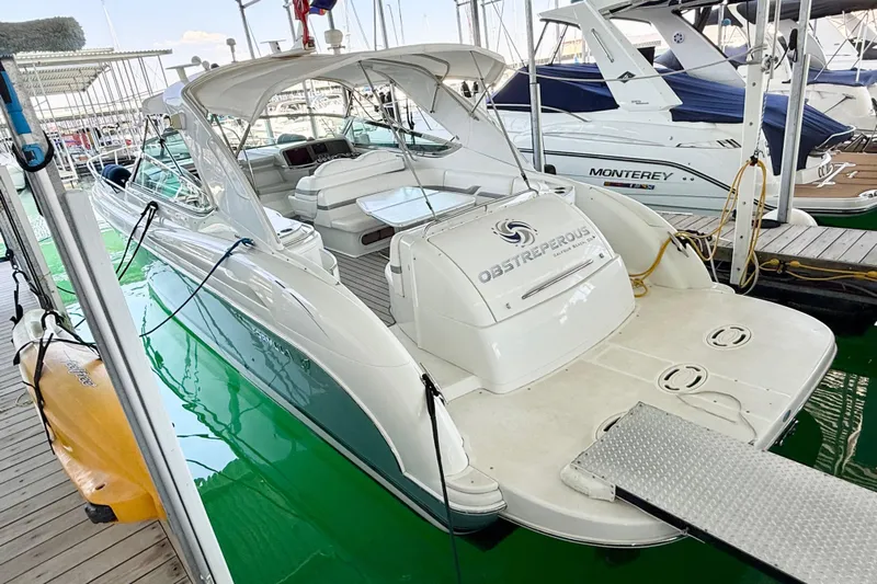 Obstreperous Yacht Photos Pics 2004 Formula 400 Super Sport yacht docked at marina, featuring sleek design and spacious deck.