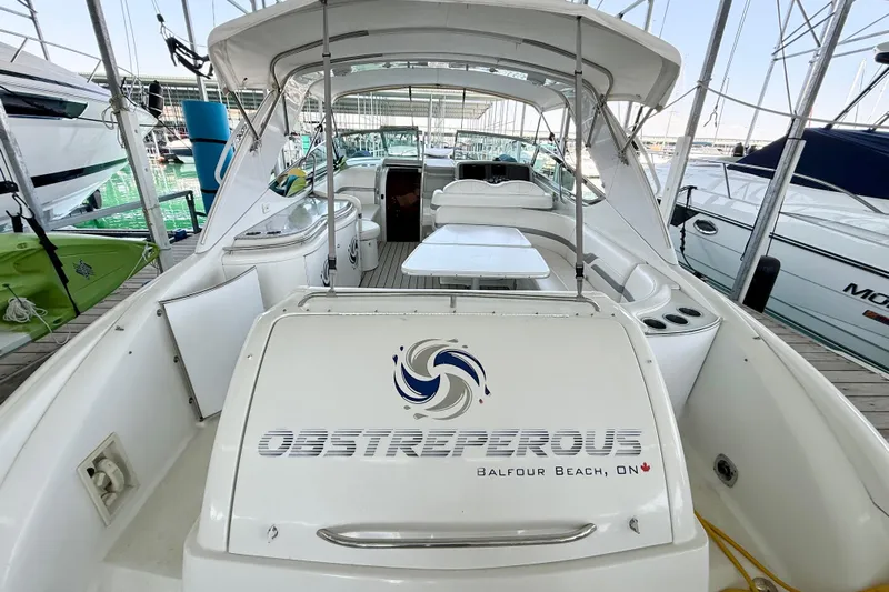 Obstreperous Yacht Photos Pics 2004 Formula 400 Super Sport boat docked, featuring spacious seating and sleek design.