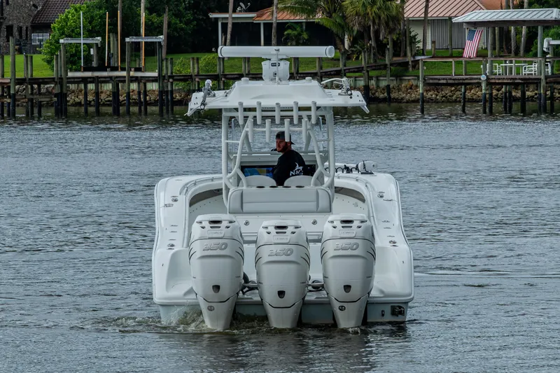  Yacht Photos Pics 2018 Yellowfin 36 Offshore boat with triple engines on a calm waterway.