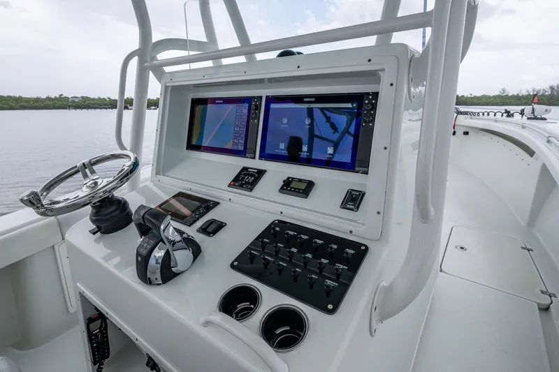  Yacht Photos Pics 2018 Yellowfin 36 Offshore boat cockpit with dual navigation screens and steering wheel.