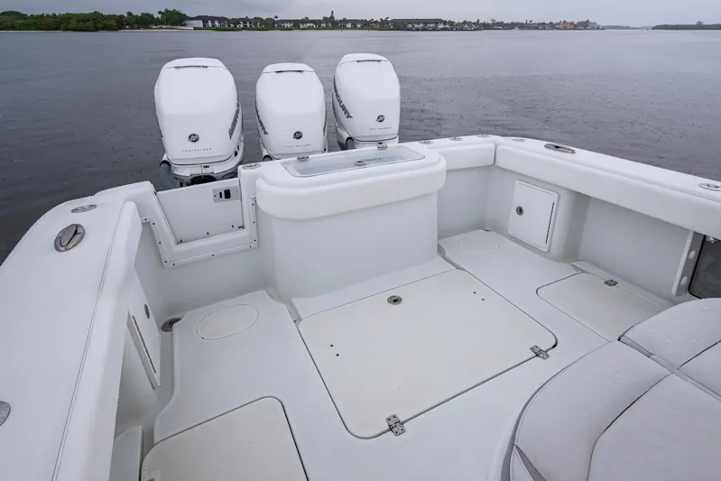  Yacht Photos Pics 2018 Yellowfin 36 Offshore boat with triple outboard engines on calm water.