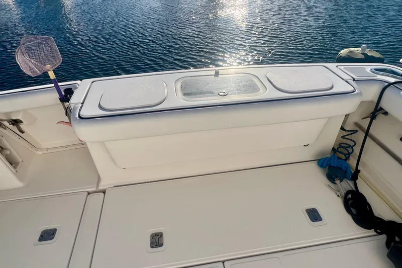 Blue Pearl Yacht Photos Pics 2005 Tiara Yachts 3200 Open boat deck with storage compartments and fishing net.