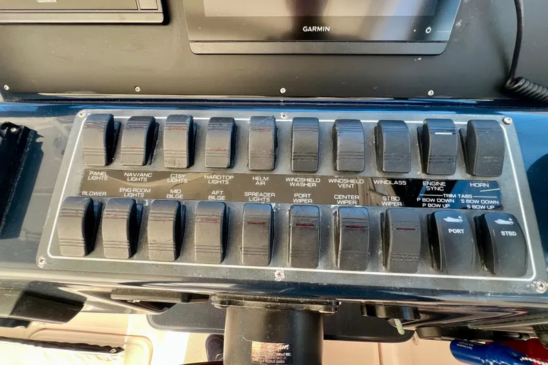 Blue Pearl Yacht Photos Pics Control panel of a 2005 Tiara Yachts 3200 Open with labeled switches and Garmin display.