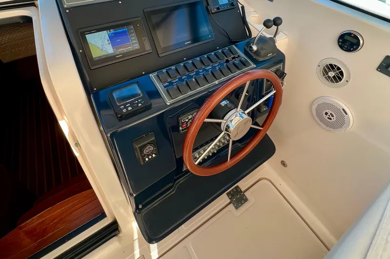 Blue Pearl Yacht Photos Pics 2005 Tiara Yachts 3200 Open helm with wooden steering wheel and navigation controls.