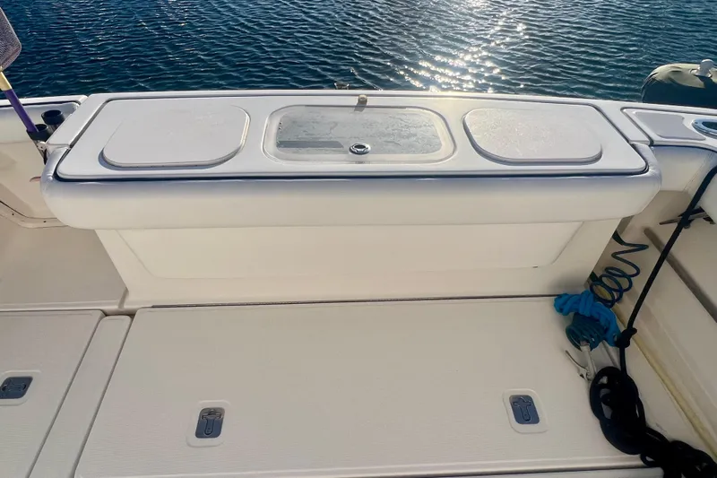 Blue Pearl Yacht Photos Pics 2005 Tiara Yachts 3200 Open deck with storage compartments and ocean view.