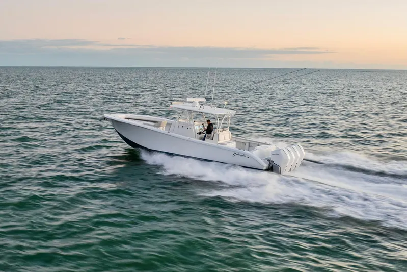  Yacht Photos Pics 2016 Yellowfin 39 Offshore boat cruising on open water at sunset.