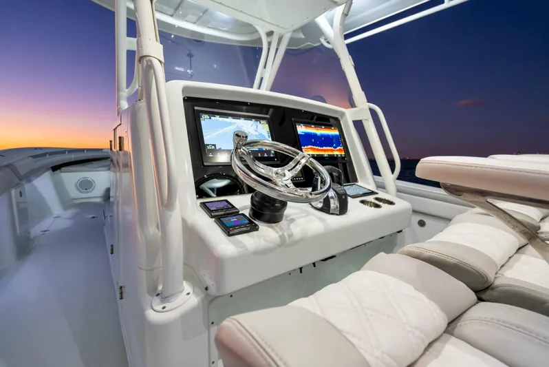  Yacht Photos Pics 2016 Yellowfin 39 Offshore boat console at sunset, featuring advanced navigation displays.