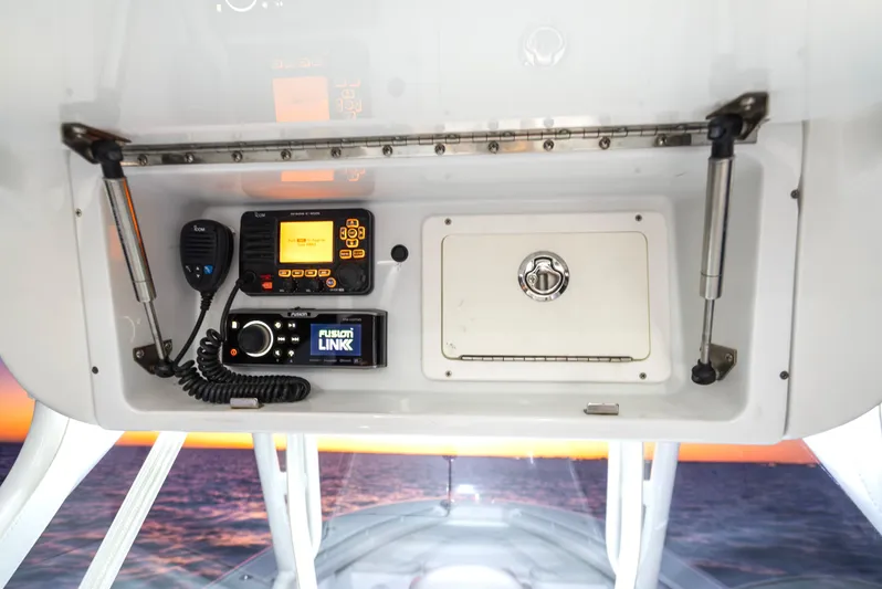  Yacht Photos Pics 2016 Yellowfin 39 Offshore boat console with radio and control panel at sunset.