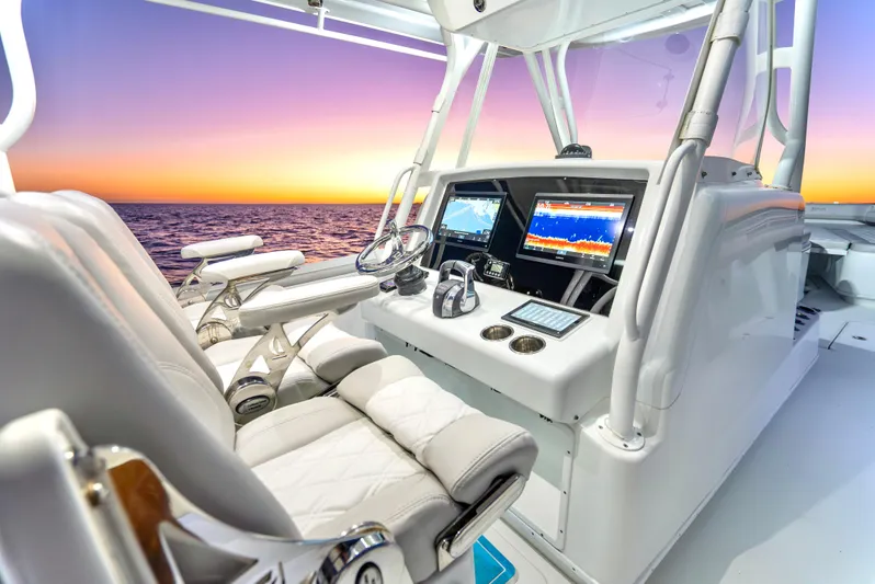  Yacht Photos Pics 2016 Yellowfin 39 Offshore boat cockpit with advanced navigation systems at sunset.
