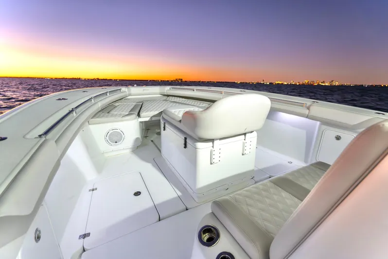  Yacht Photos Pics 2016 Yellowfin 39 Offshore boat interior at sunset, showcasing seating and ocean view.