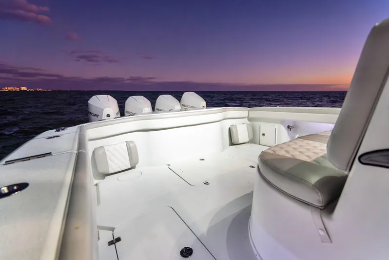  Yacht Photos Pics 2016 Yellowfin 39 Offshore boat at sunset, featuring spacious deck and multiple engines.