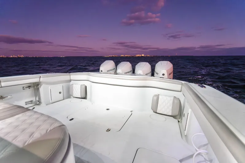  Yacht Photos Pics 2016 Yellowfin 39 Offshore boat at sunset, featuring spacious deck and multiple engines.