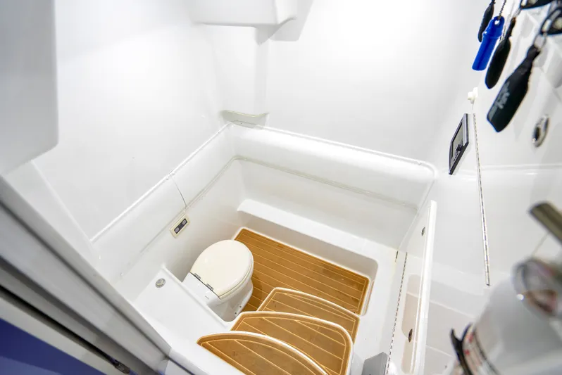  Yacht Photos Pics 2016 Yellowfin 39 Offshore boat bathroom with wooden flooring and white fixtures.