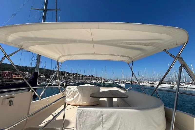  Yacht Photos Pics 1998 Riva Dolce Vita yacht deck with canopy, overlooking marina and sailboats.