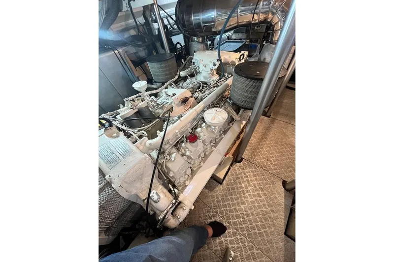  Yacht Photos Pics Engine room of a 1998 Riva Dolce Vita yacht, showcasing detailed machinery components.