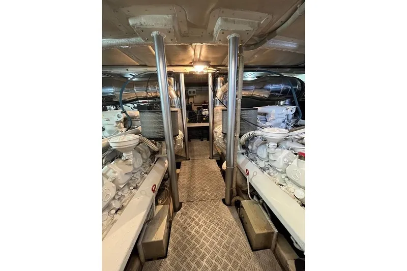  Yacht Photos Pics Engine room of a 1998 Riva Dolce Vita yacht, showcasing dual engines and metallic components.