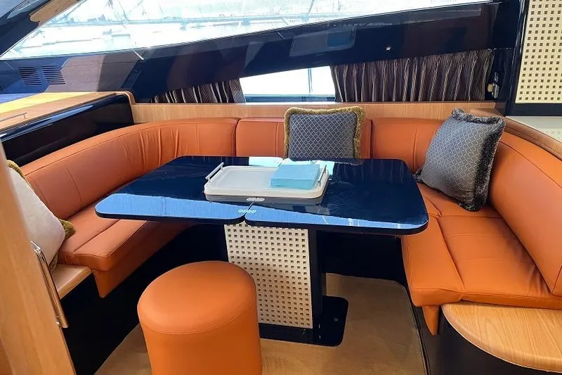  Yacht Photos Pics Luxurious 1998 Riva Dolce Vita yacht interior with orange seating and elegant decor.