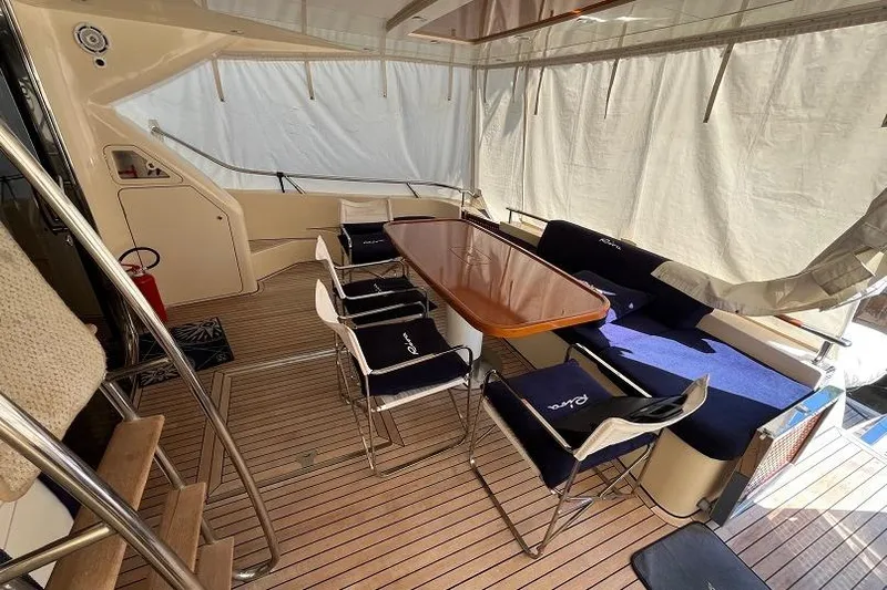  Yacht Photos Pics Interior of a 1998 Riva Dolce Vita yacht with elegant seating and wooden table.