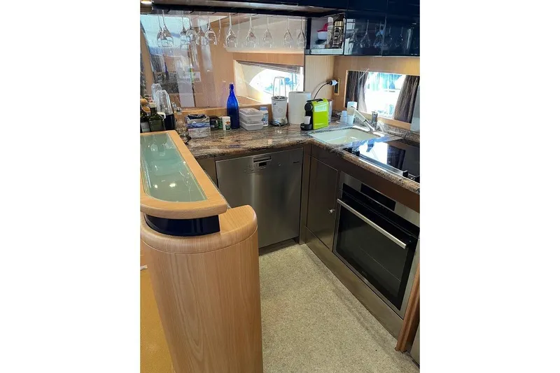  Yacht Photos Pics Luxurious kitchen interior of a 1998 Riva Dolce Vita yacht, featuring modern appliances.
