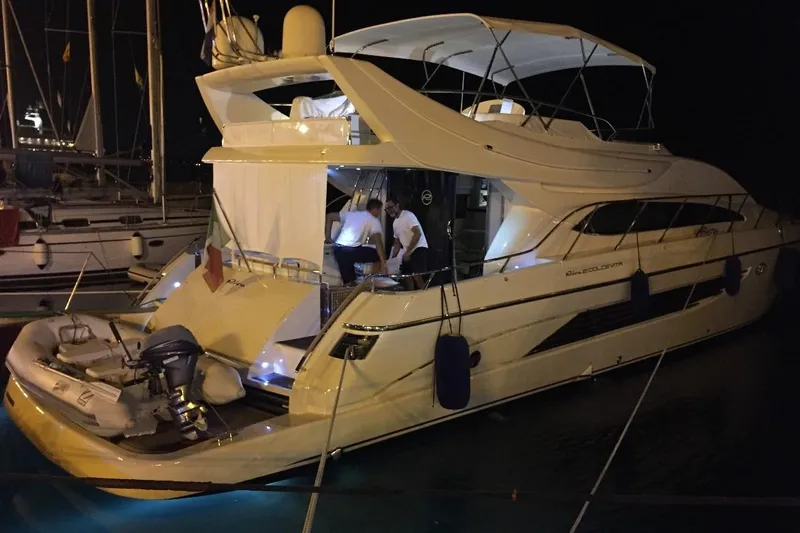  Yacht Photos Pics Luxurious 1998 Riva Dolce Vita yacht docked at night with illuminated deck.