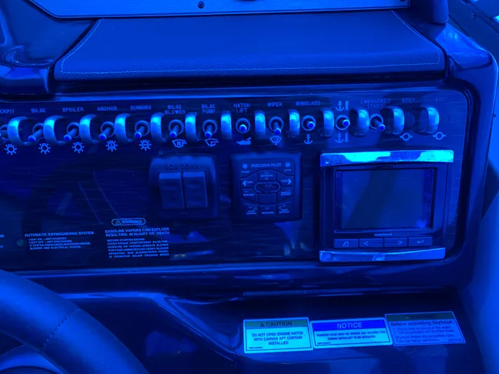  Yacht Photos Pics Control panel of a 2017 Sea Ray Sundancer 310 boat, featuring switches and a display screen.