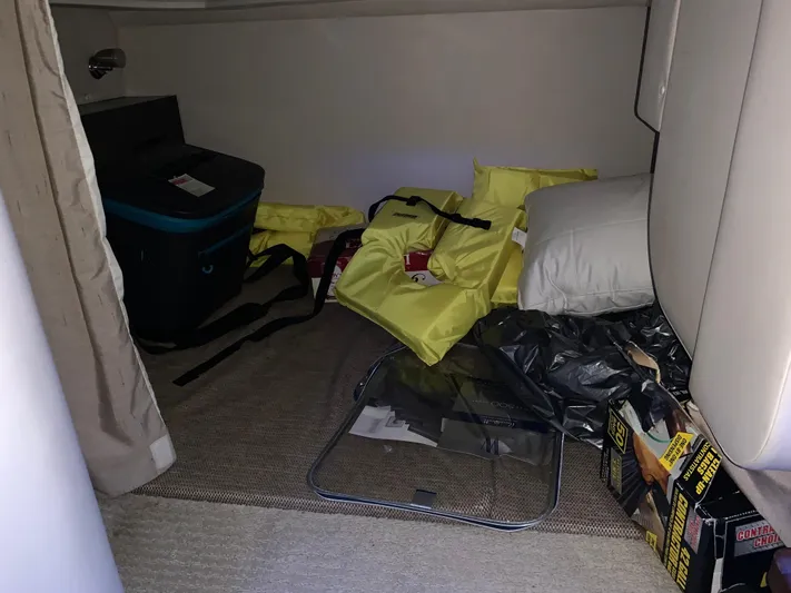  Yacht Photos Pics Interior cabin of 2017 Sea Ray Sundancer 310 with life jackets and storage items.