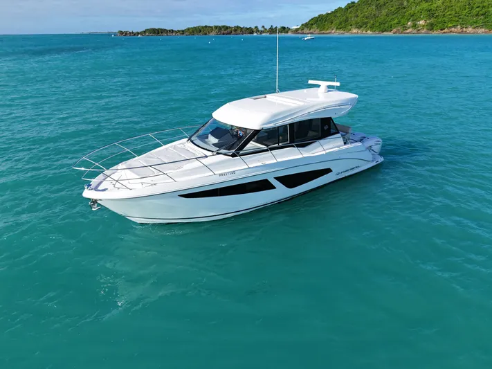  Yacht Photos Pics 2022 Regal 42 XO yacht cruising in clear blue waters.