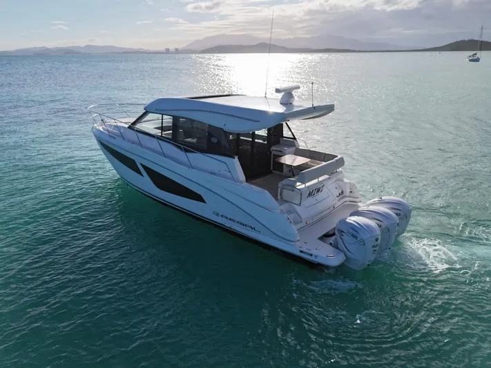  Yacht Photos Pics 2022 Regal 42 XO yacht cruising on serene waters at sunset.