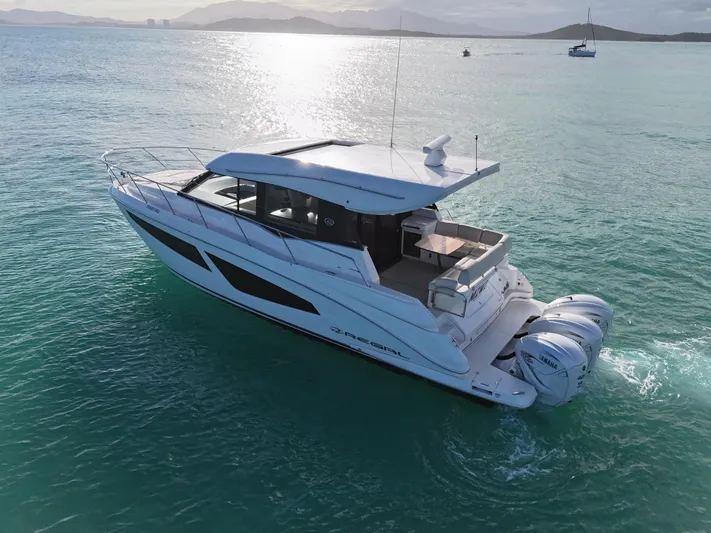  Yacht Photos Pics 2022 Regal 42 XO yacht cruising on serene turquoise waters.