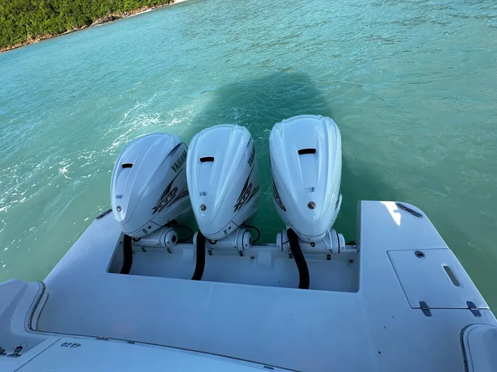  Yacht Photos Pics 2022 Regal 42 XO boat with triple Yamaha outboard engines on turquoise water.