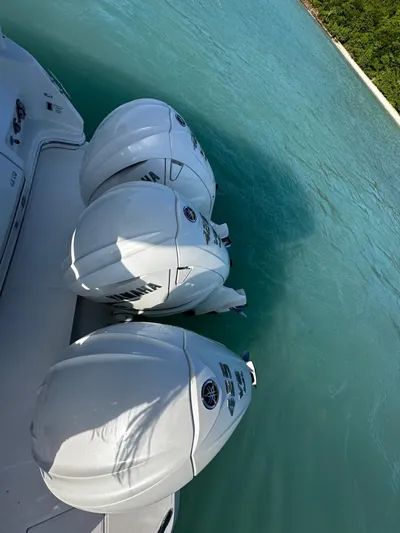  Yacht Photos Pics 2022 Regal 42 XO boat with triple outboard engines on turquoise water.