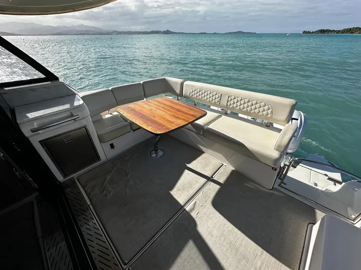  Yacht Photos Pics Luxurious 2022 Regal 42 XO yacht deck with seating and ocean view.