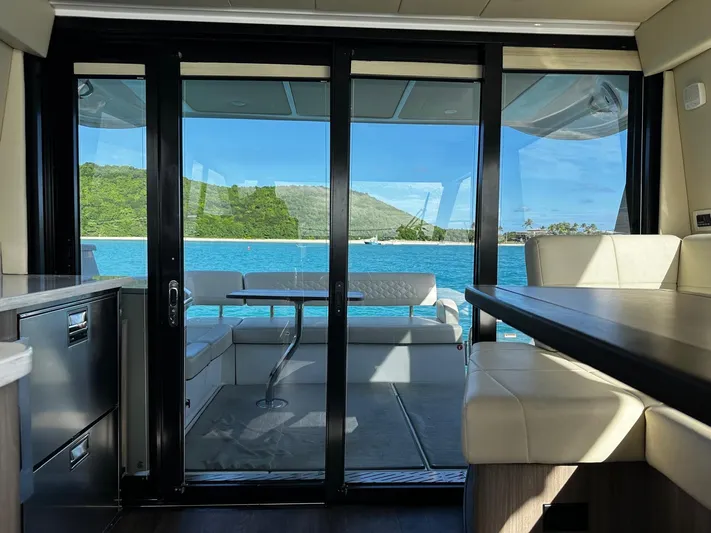  Yacht Photos Pics Interior view of 2022 Regal 42 XO yacht with ocean and island backdrop.