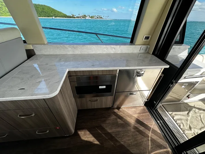 Yacht Photos Pics Interior of 2022 Regal 42 XO yacht with sleek kitchen and ocean view.