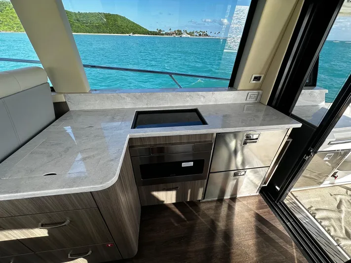  Yacht Photos Pics Luxurious 2022 Regal 42 XO yacht interior with sleek kitchen and ocean view.