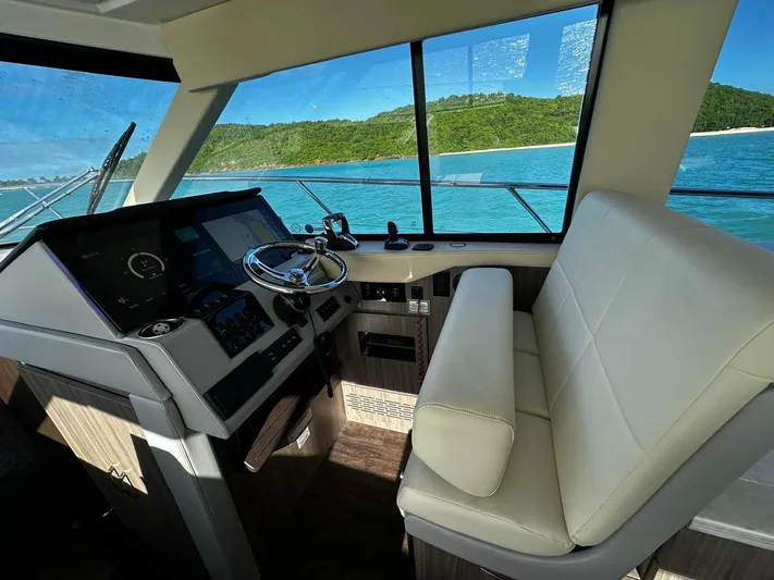  Yacht Photos Pics Interior of 2022 Regal 42 XO yacht with helm and ocean view.