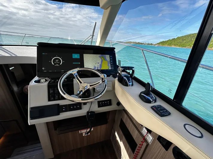  Yacht Photos Pics 2022 Regal 42 XO yacht helm with modern navigation system and ocean view.