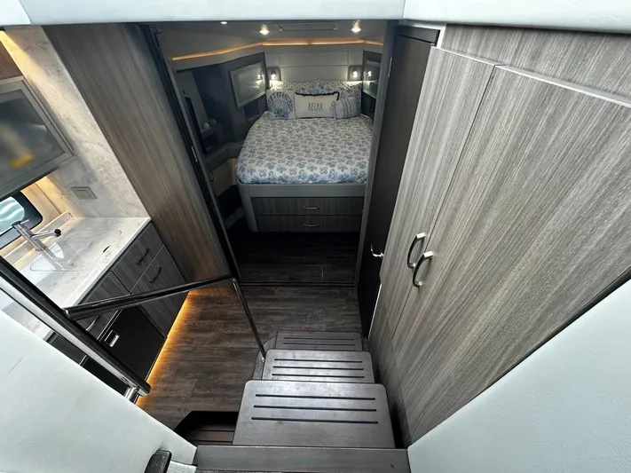  Yacht Photos Pics Luxurious interior of 2022 Regal 42 XO yacht with cozy bedroom and modern amenities.