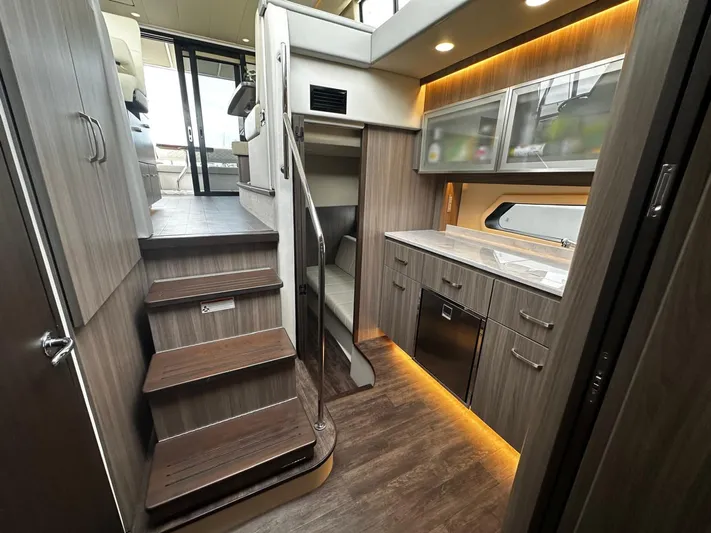  Yacht Photos Pics Luxurious interior of 2022 Regal 42 XO yacht with modern kitchen and wooden stairs.