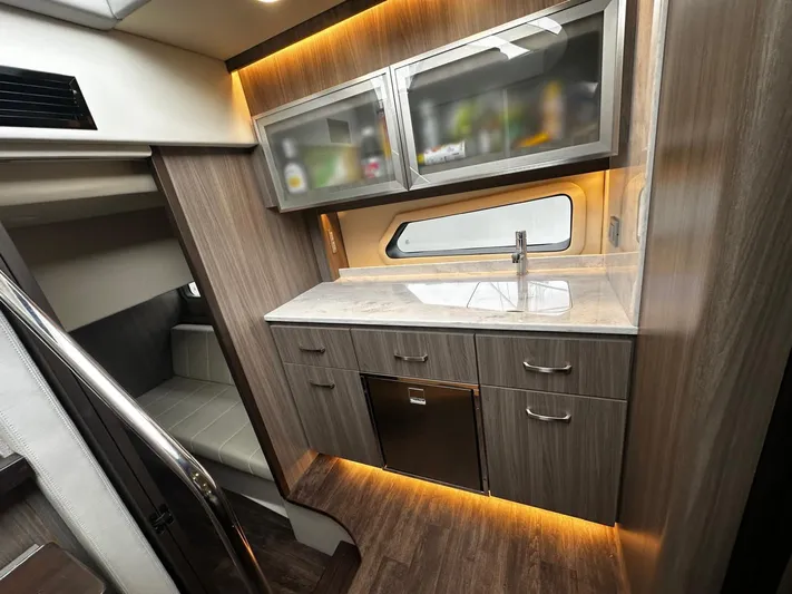  Yacht Photos Pics Luxurious interior of 2022 Regal 42 XO yacht with modern kitchenette and ambient lighting.