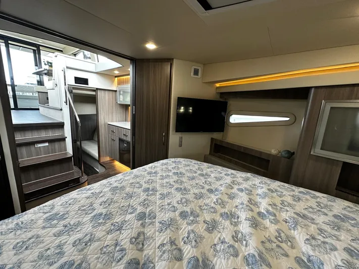  Yacht Photos Pics Interior of 2022 Regal 42 XO yacht with modern bedroom and staircase.