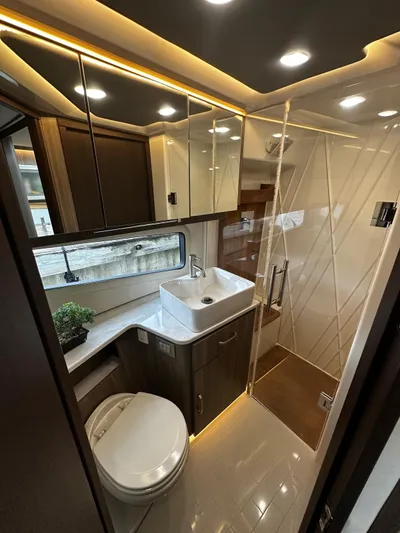  Yacht Photos Pics Luxurious bathroom in 2022 Regal 42 XO yacht with modern fixtures and elegant design.