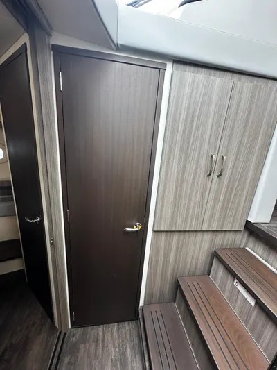  Yacht Photos Pics Interior of 2022 Regal 42 XO yacht with wood paneling and stairs.