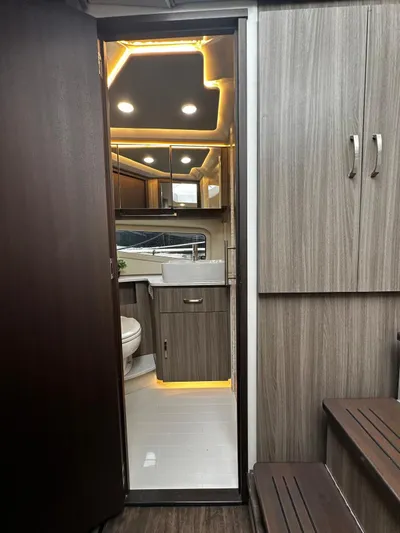  Yacht Photos Pics Luxurious interior of 2022 Regal 42 XO yacht with modern wood finishes and ambient lighting.