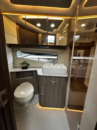  Yacht Photos Pics Luxurious bathroom in 2022 Regal 42 XO yacht with modern fixtures and ambient lighting.