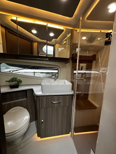  Yacht Photos Pics Luxurious bathroom in 2022 Regal 42 XO yacht with modern fixtures and elegant lighting.