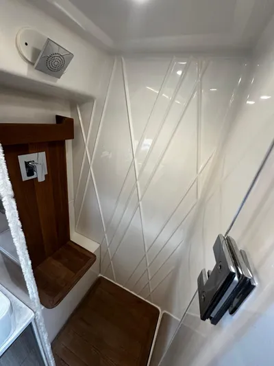  Yacht Photos Pics Modern shower interior in 2022 Regal 42 XO yacht with sleek design and wood accents.
