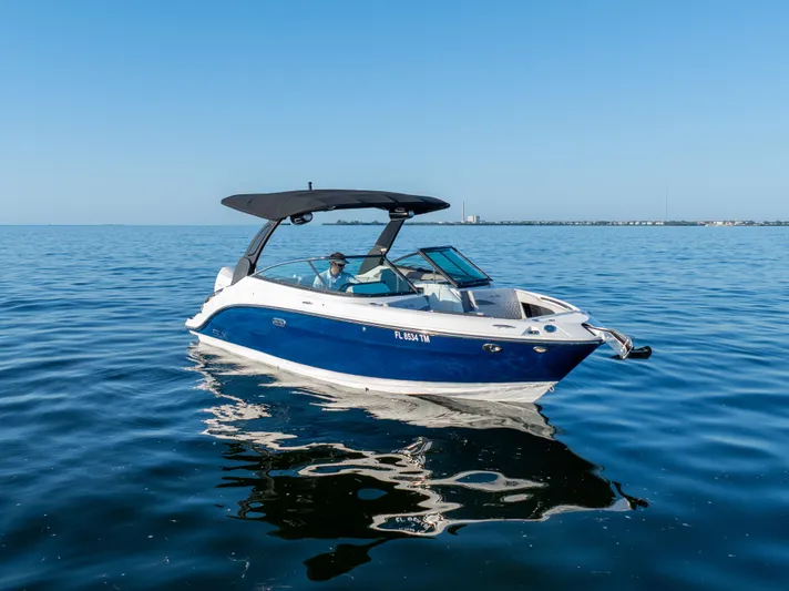  Yacht Photos Pics 2023 Sea Ray SLX 260 Outboard boat cruising on calm blue waters.